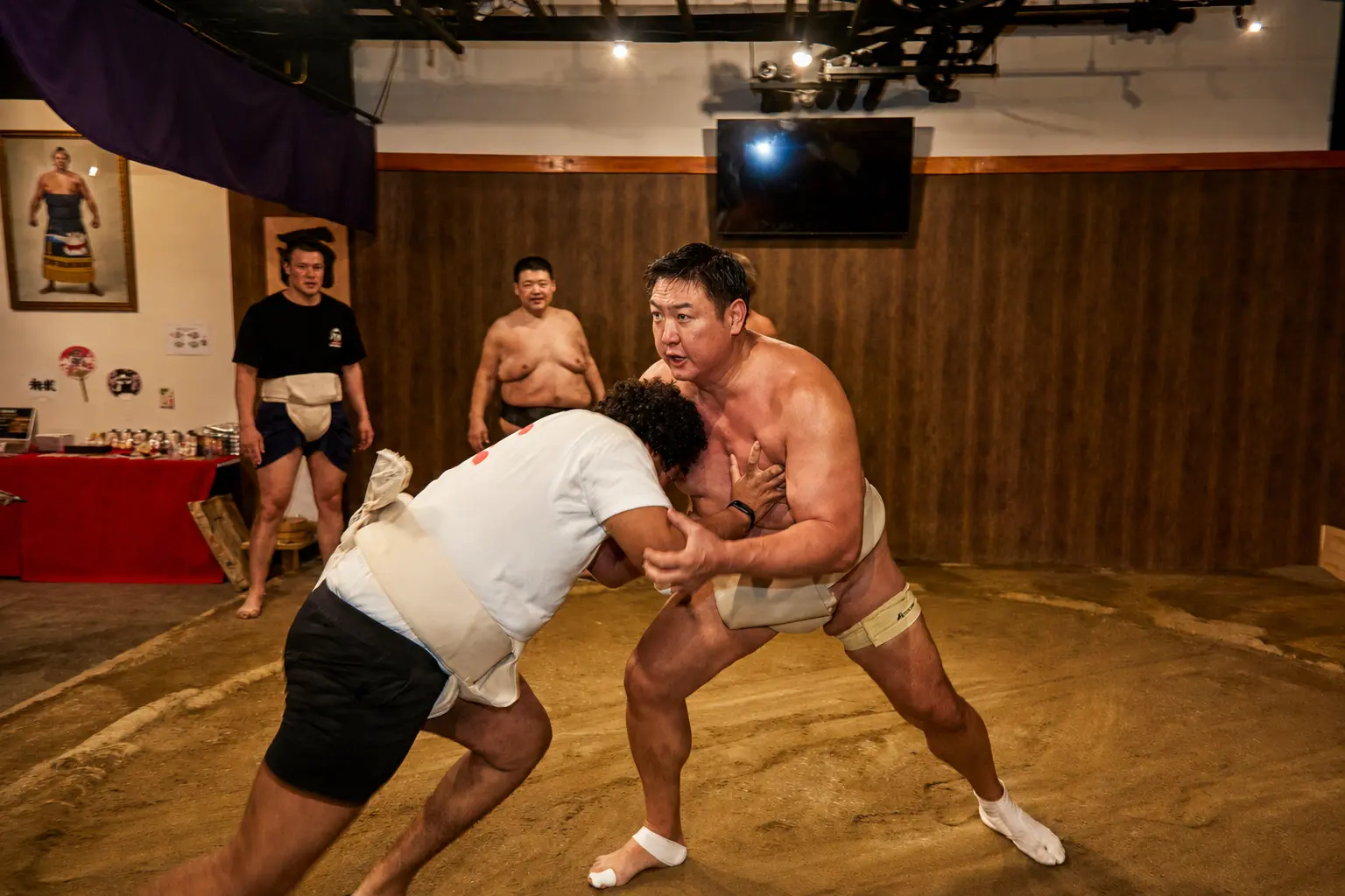 A guest challenging a sumo wrestler on the dohyo