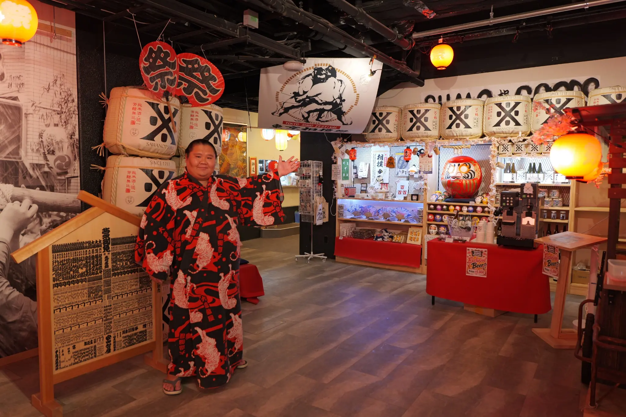 A sumo wrestler welcoming guests inside Tokyo Sumo Festival in Ginza